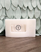Rectangular product with 'Teleties' branding on a textured green background