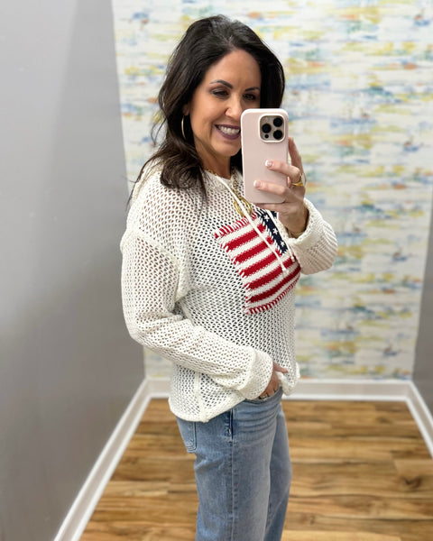 woman wearing american flag knit sweater in white