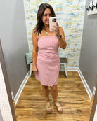 woman wearing a strapless red and white stripe dress.