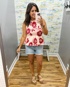 woman wearing a floral sweater tank. 