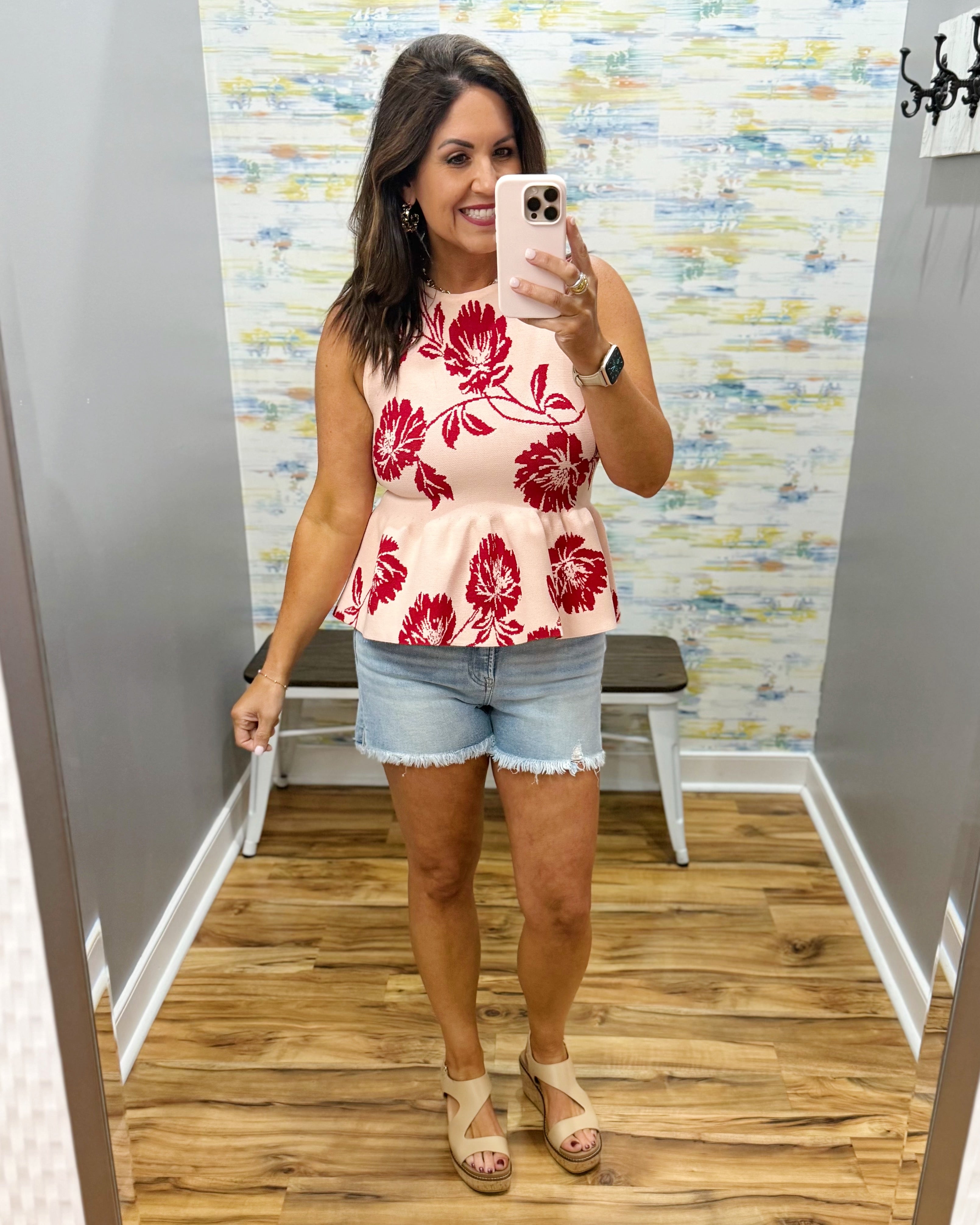 woman wearing a floral sweater tank. 