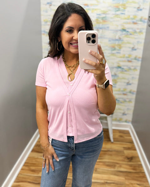 woman wearing pink top and gold chunky necklace
