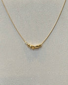 dainty gold nugget necklace.