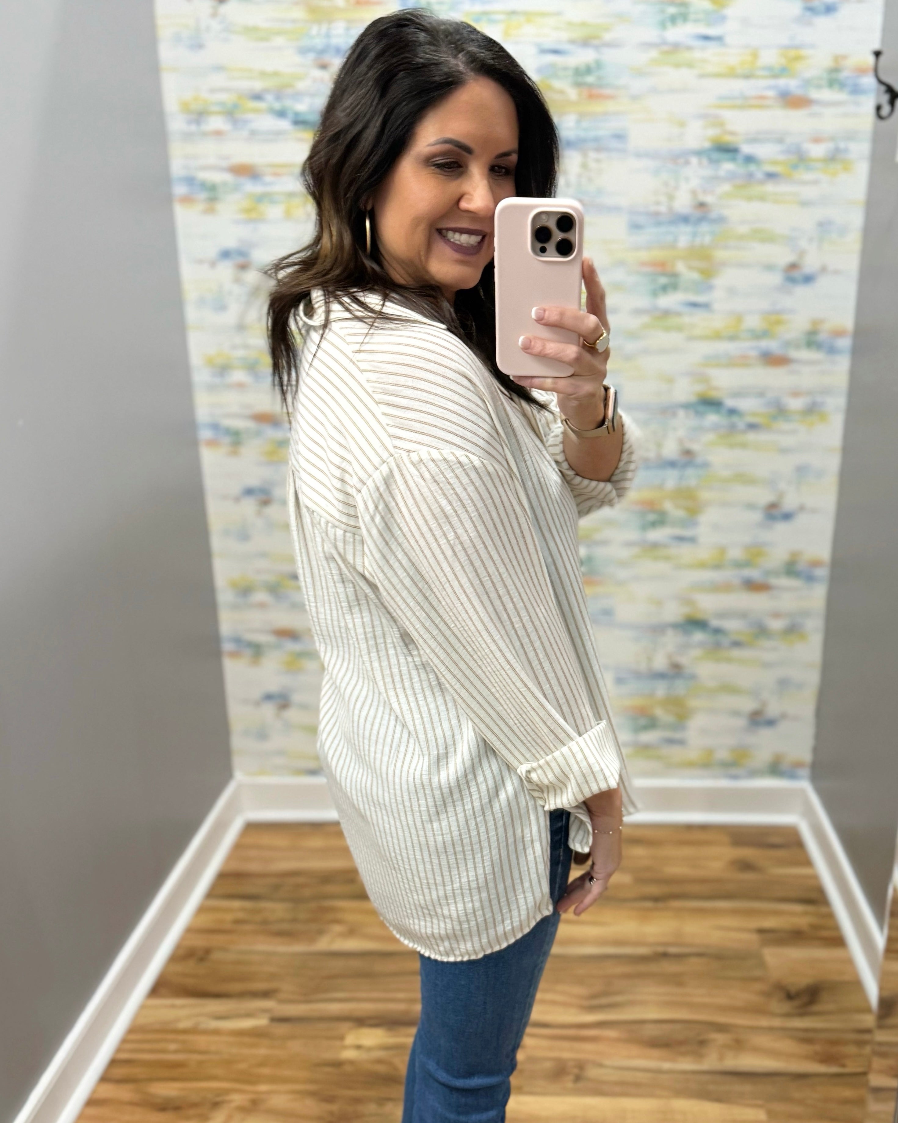 woman wearing a stripe blouse in mocha and white