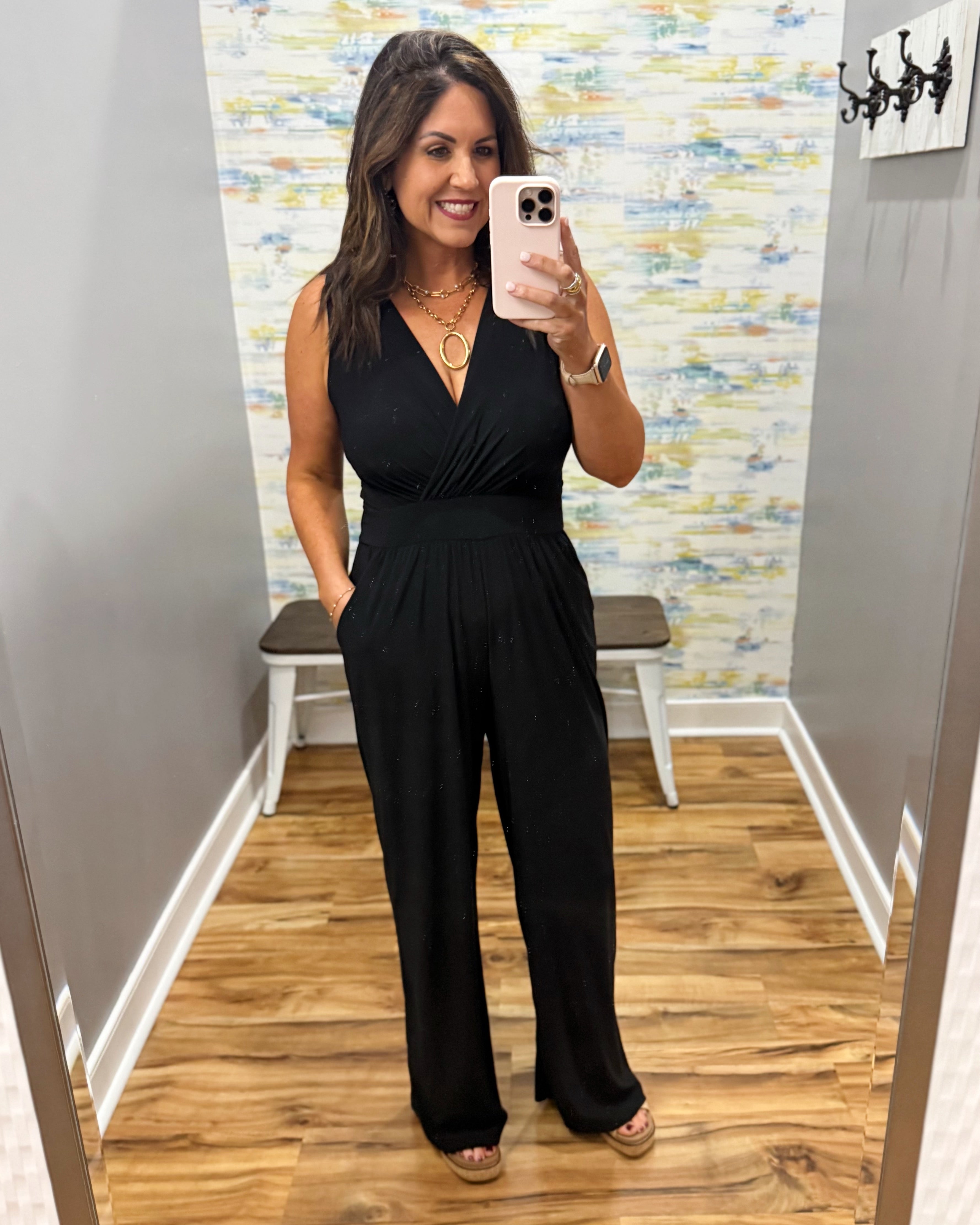 woman wearing a black jumpsuit.