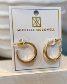 Gold hoop earrings on a Michelle McDowell branded card.