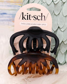 Two Kit Sch hair claw clips on a display card, one solid black and one tortoiseshell brown, for thick, long, and curly hair.
