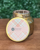 Gold glittery candle jar with 'Sweet Grace' label on a wooden surface