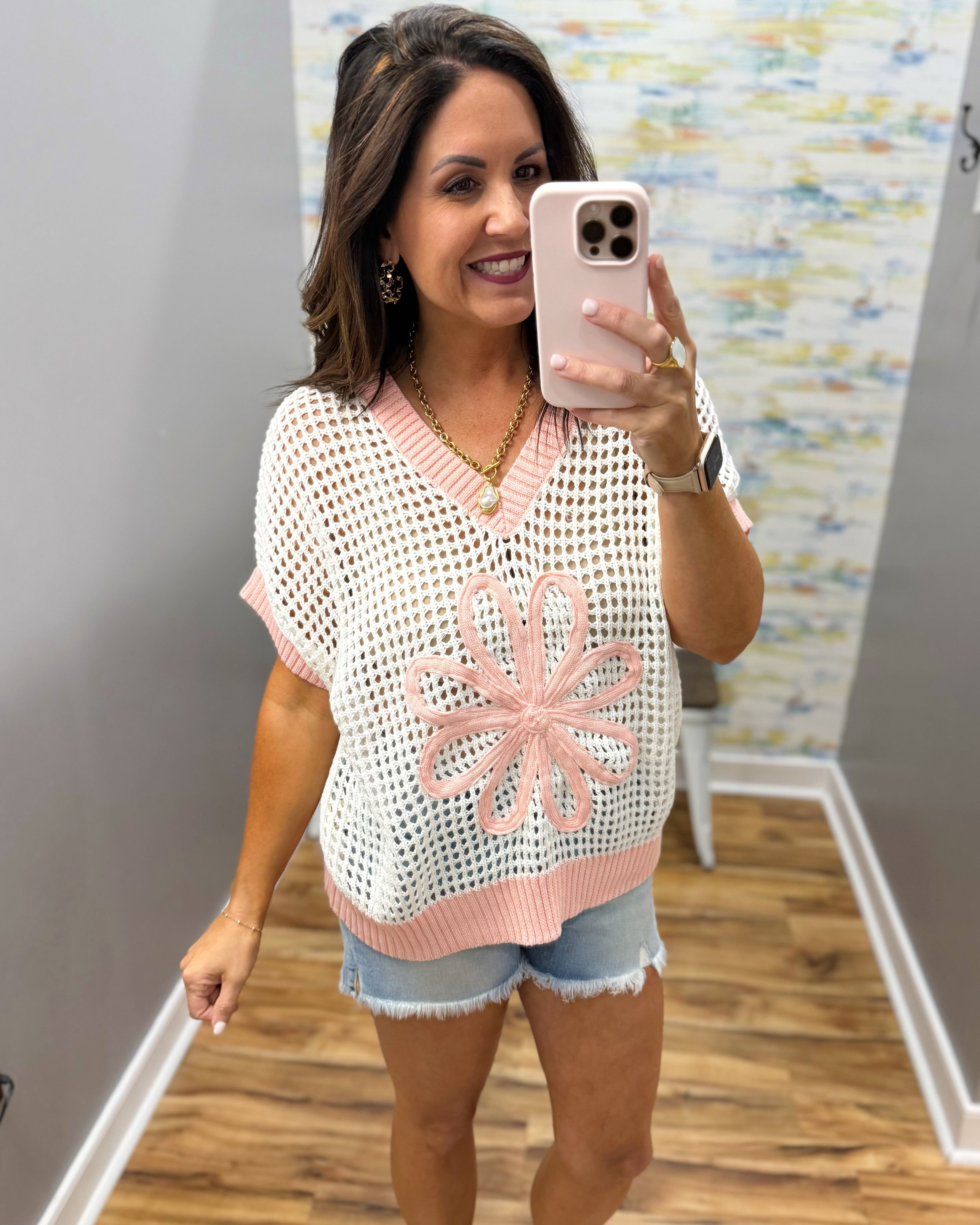 woman wearing cream sweater with pink floral print