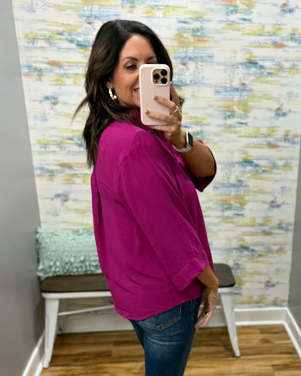woman wearing a magenta color 3/4 sleeve flowy top.