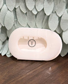 white hair claw with 'Teleties' branding on a textured green and brown background