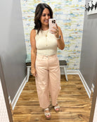woman wearing a tank and pants.