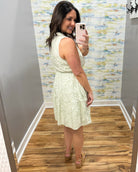 woman in sage tropical dress