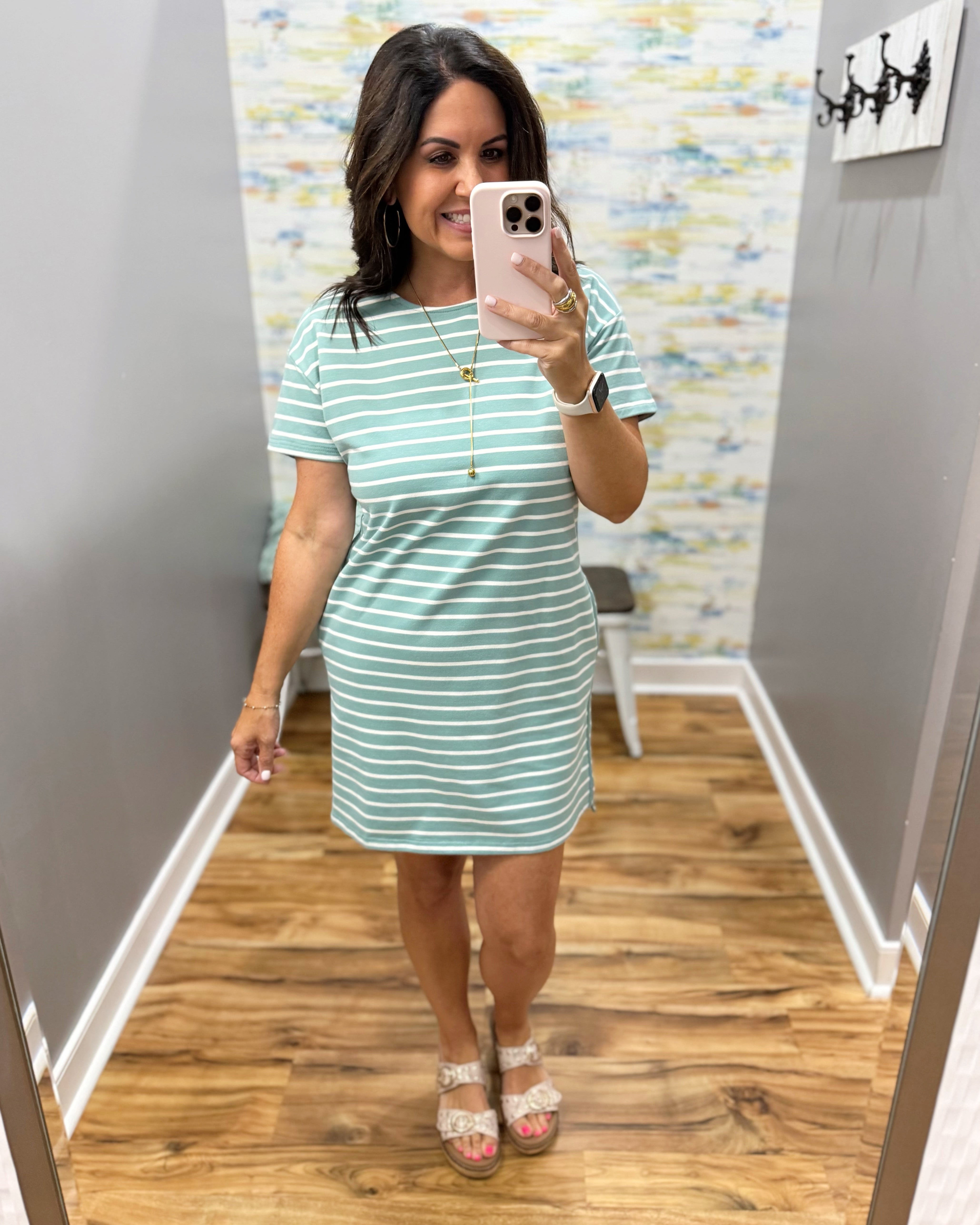 woman wearing a dark sage and white stripe dress.