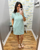 woman wearing a dark sage and white stripe dress.