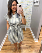 Woman wearing a black and white striped dress.