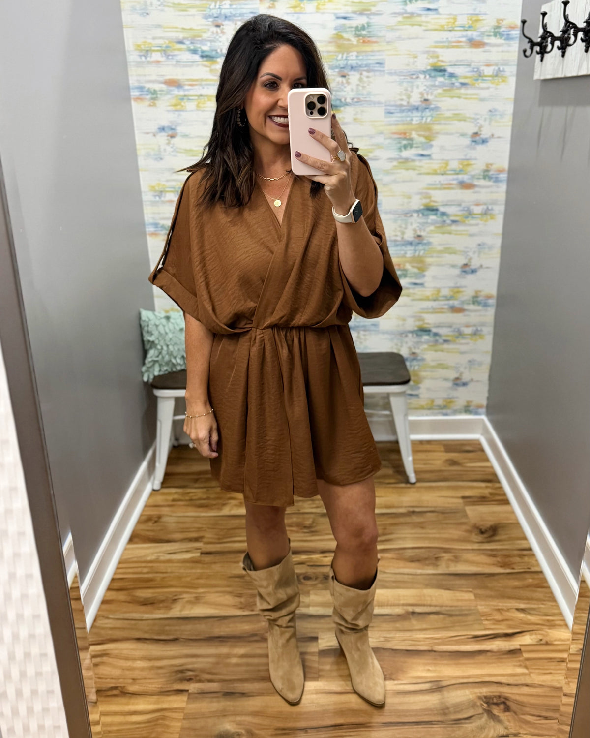 woman taking a selfie wearing a camel color wrap dress featuring a V-neckline, cinched waist, and flowy short sleeves for a feminine silhouette.