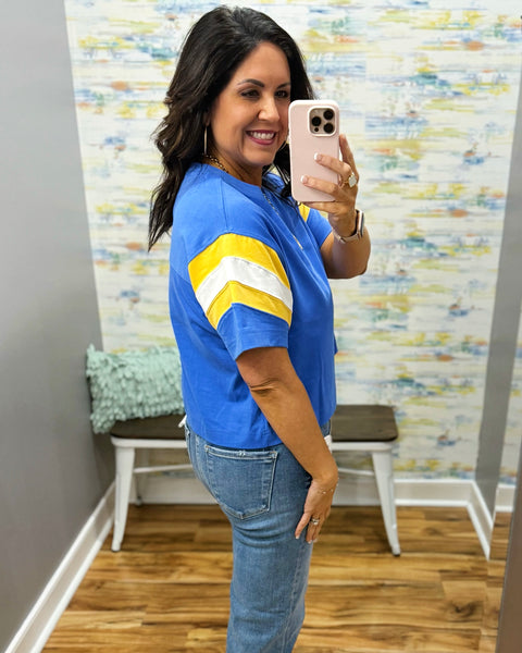 woman showing a side angle of blue tee she is wearing