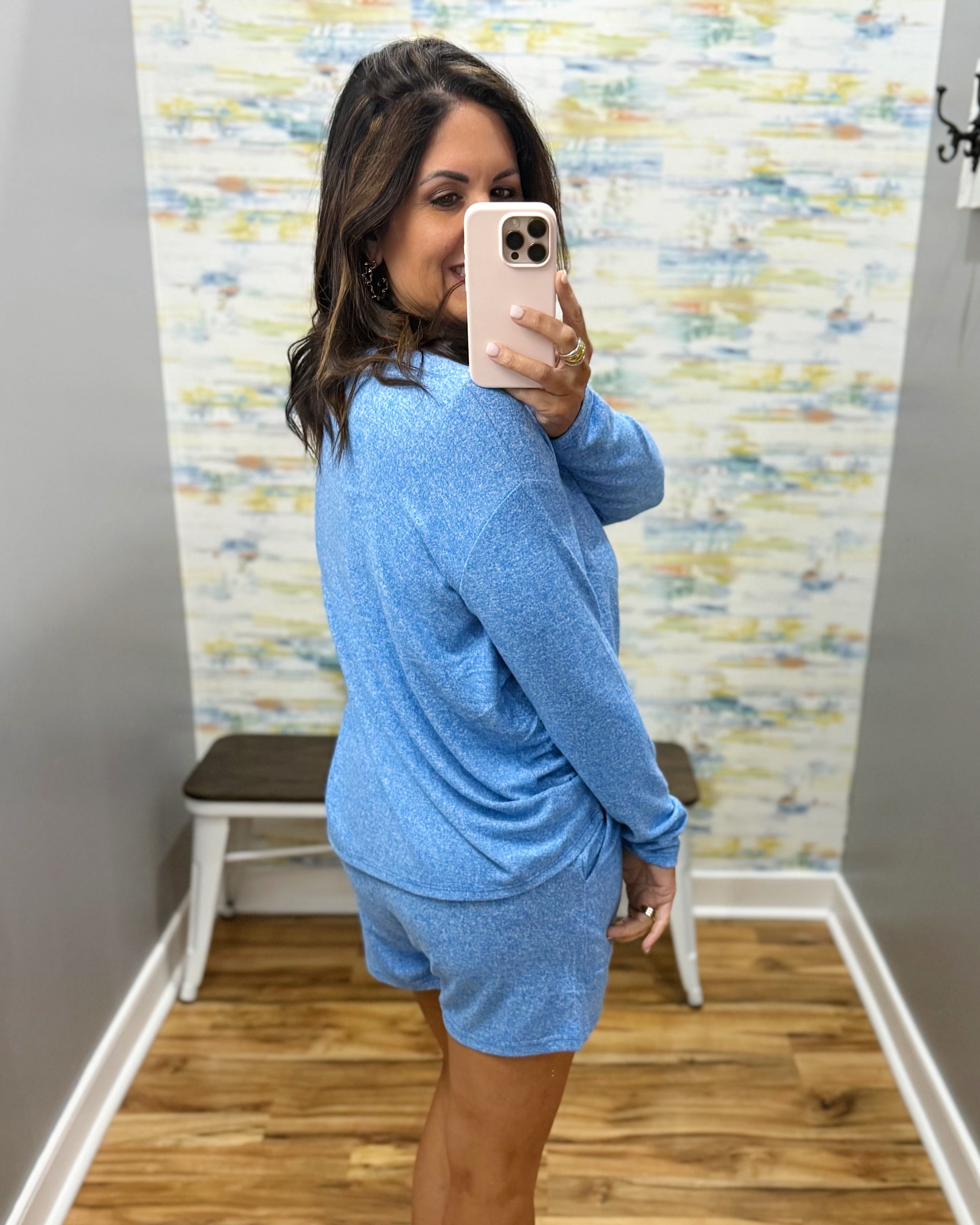 woman wearing blue lounge top and shorts set.