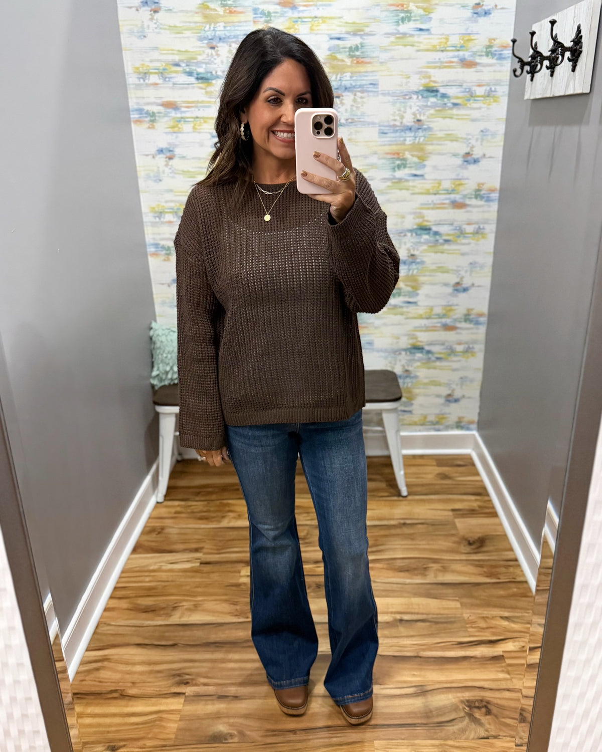 woman taking a selfie wearing a brown crochet knit sweater with Judy Blue dark wash flare jeans and Corky's Pity Party Wedge Shoes in cognac.