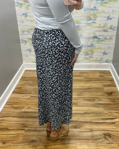 woman wearing navy blue floral midi skirt