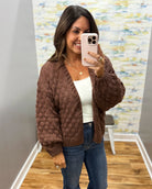 woman wearing a brown crochet sweater cardigan.