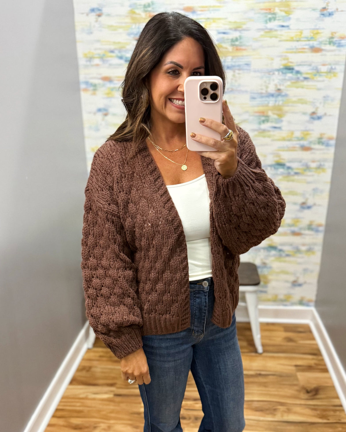 woman wearing a brown crochet sweater cardigan.