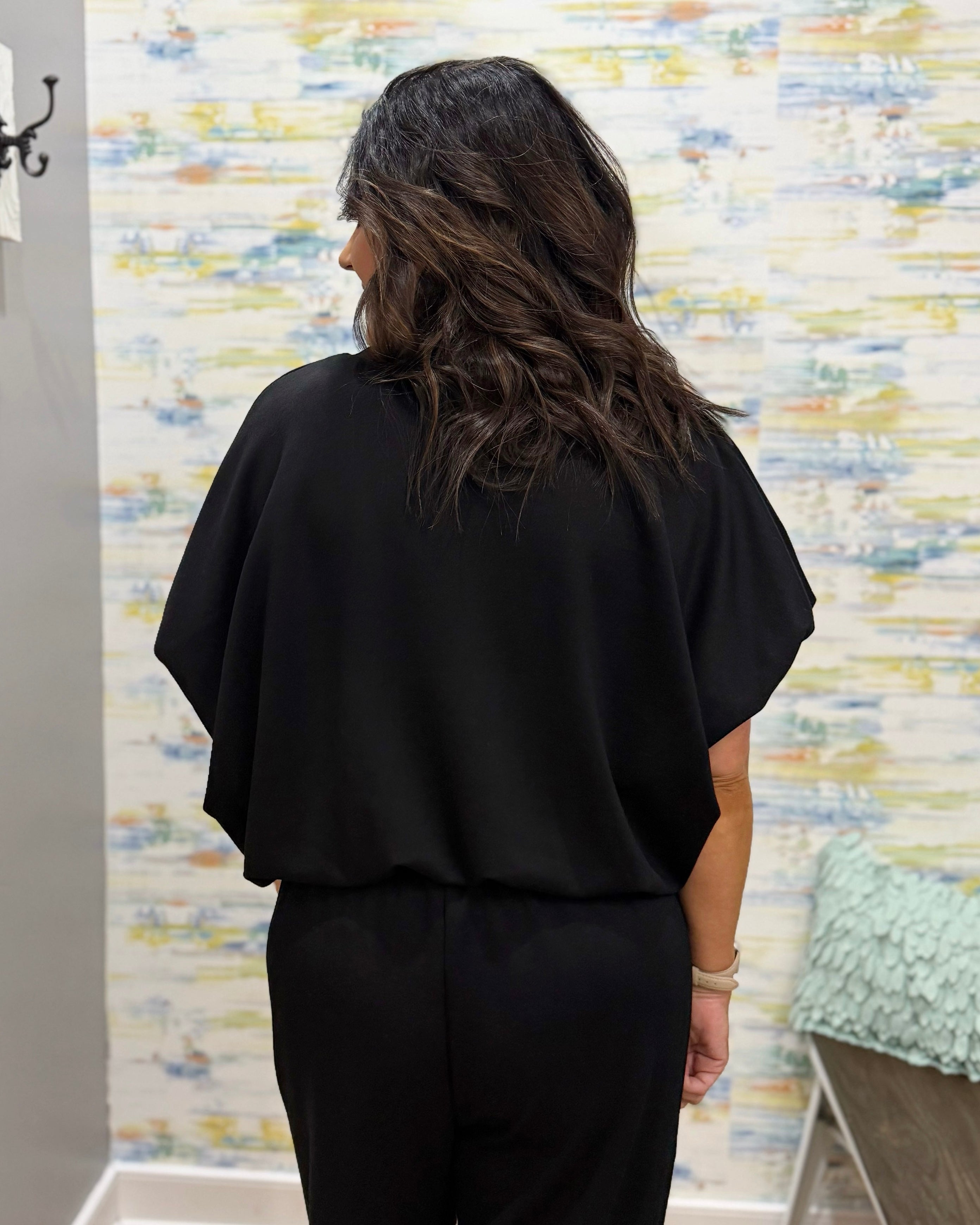 woman wearing a black scuba material top.