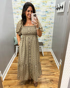 woman taking a selfie wearing a floral midi dress features a pretty square neckline and smocked detailing for a comfortable, figure-flattering fit. Decorative non-functional buttons add a classic touch, while the midi length gives it an easy, polished silhouette.