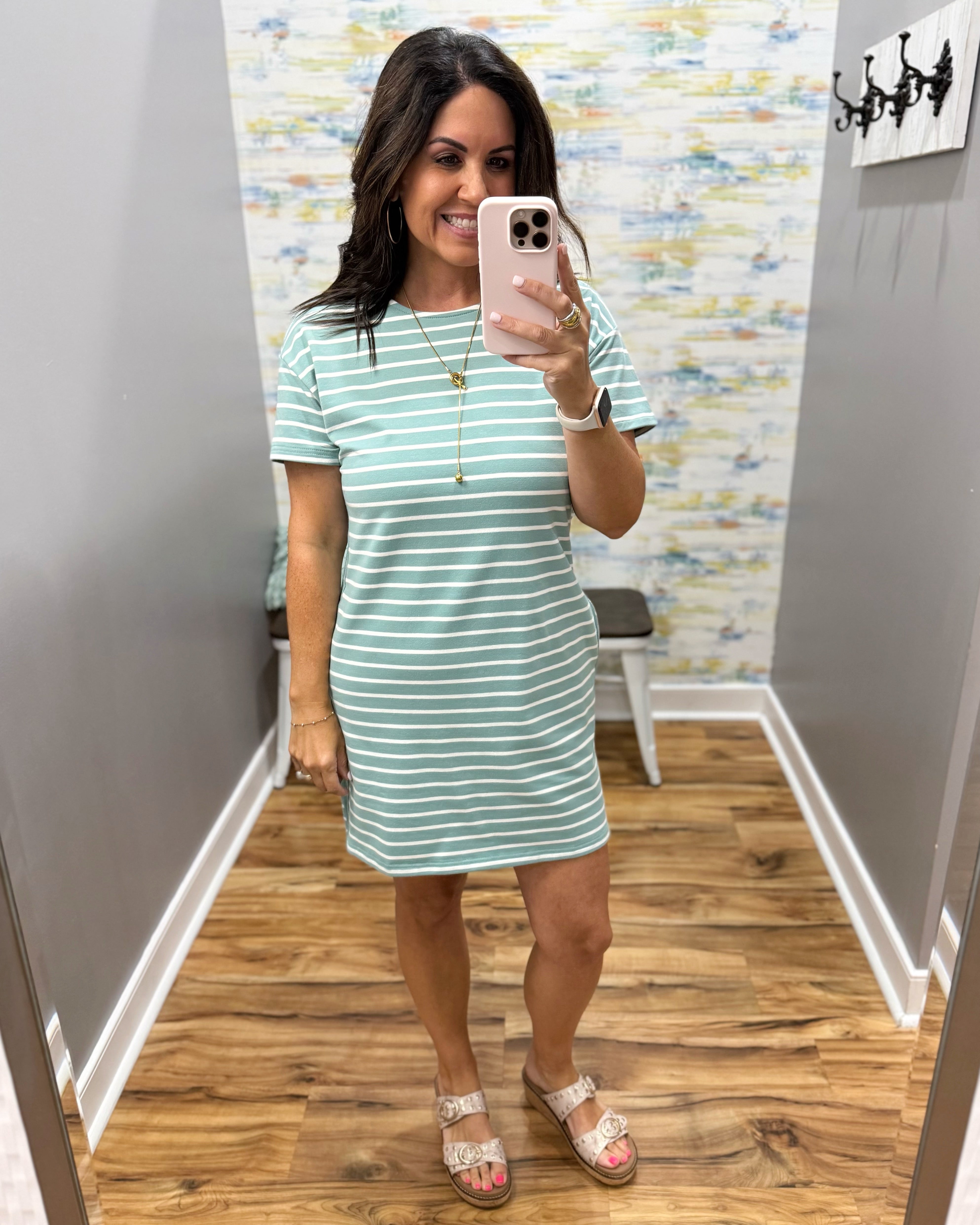 woman wearing a dark sage and white stripe dress.