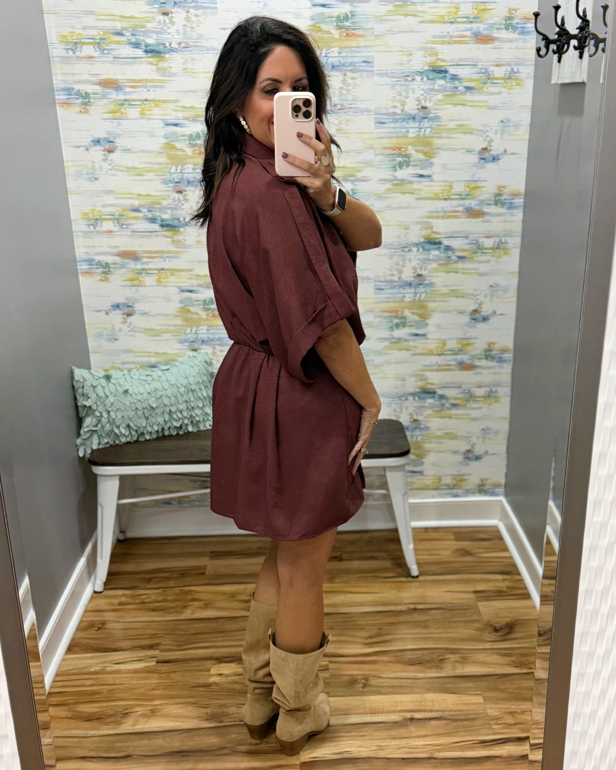 woman taking a selfie wearing a burgundy wrap dress featuring a V-neckline, cinched waist, and flowy short sleeves for a feminine silhouette.