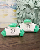 Teleties hair clips with brand label on a wooden surface