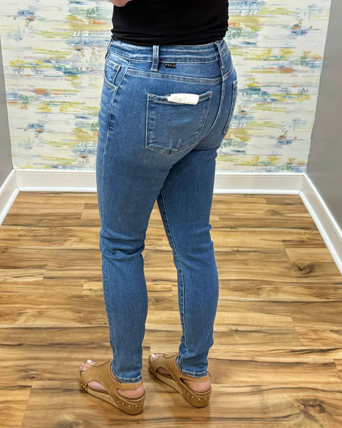 woman wearing Risen Medium Wash Tummy Control Skinny Jeans.