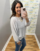 woman wearing a lightweight sweater top in stone color