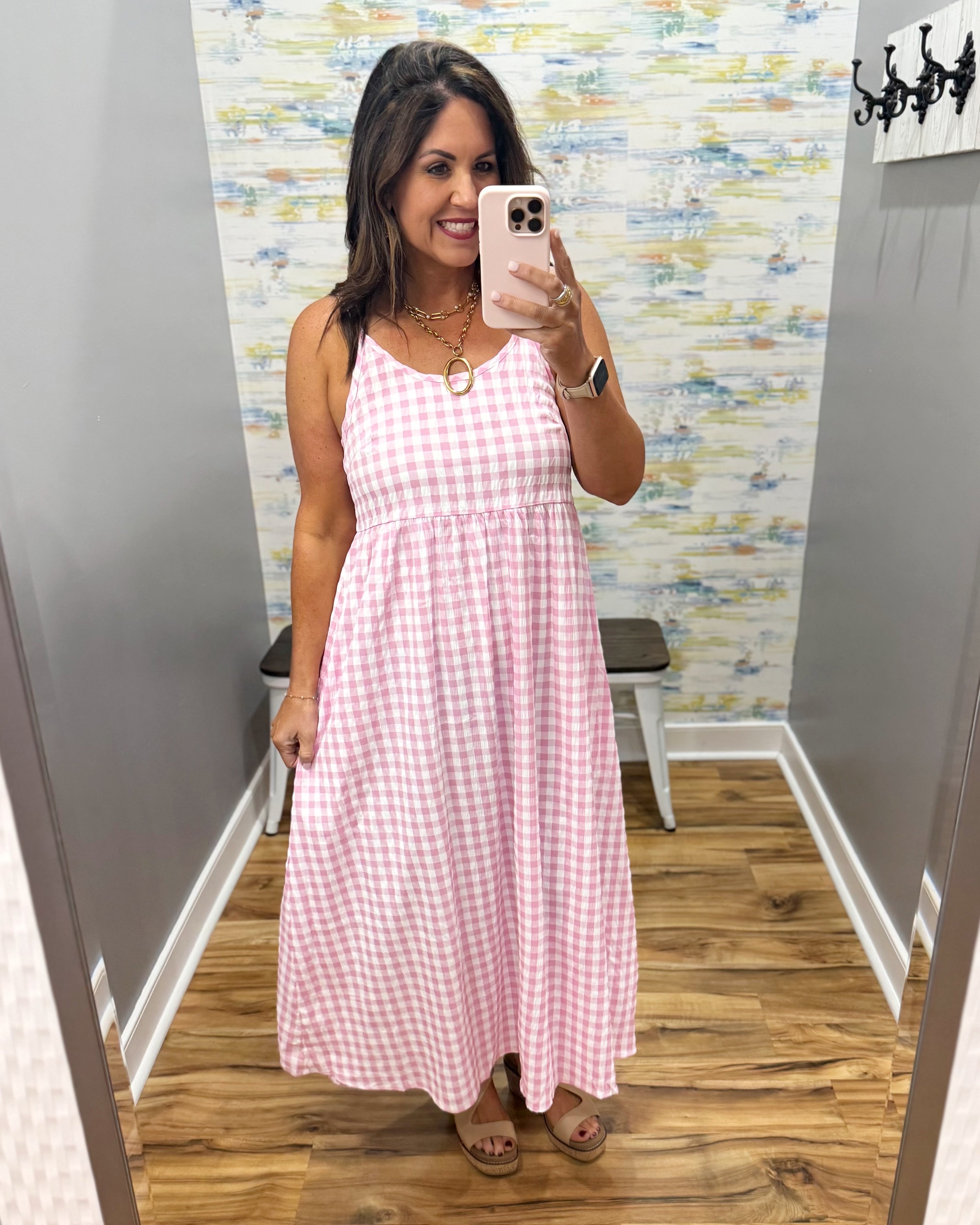 woman wearing gingham print dress in pink.