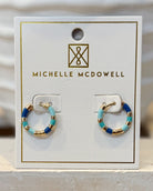 Pair of hoop earrings on a Michelle McDowell branded card.