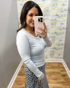 woman wearing long sleeve baby blue top