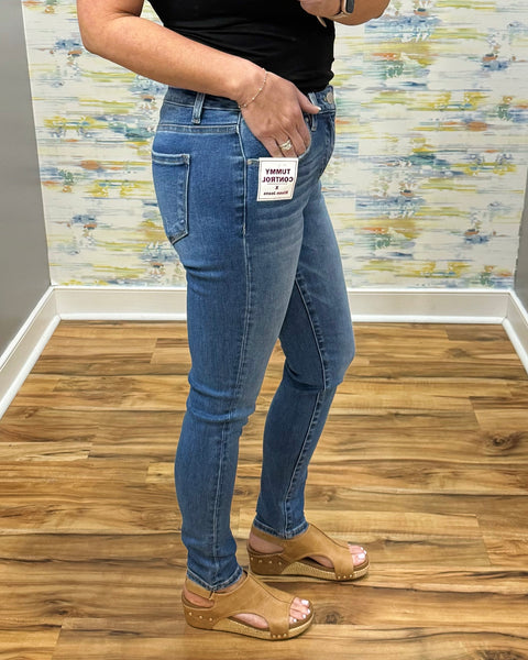 woman wearing Risen Medium Wash Tummy Control Skinny Jeans.