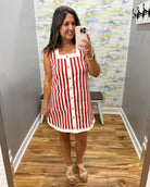 woman wearing red and white stripe dress.
