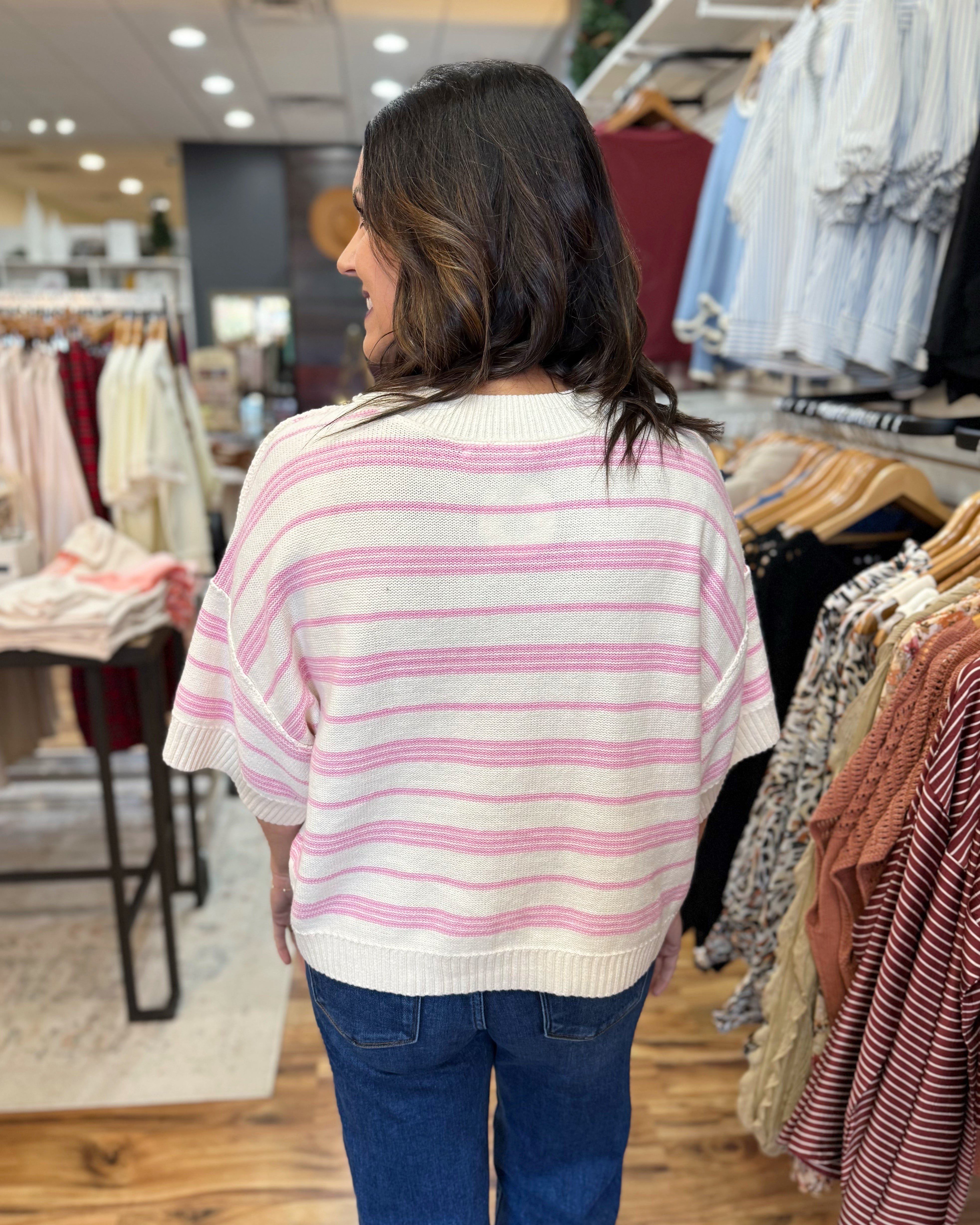 Woman wearing a striped sweater in a clothing store