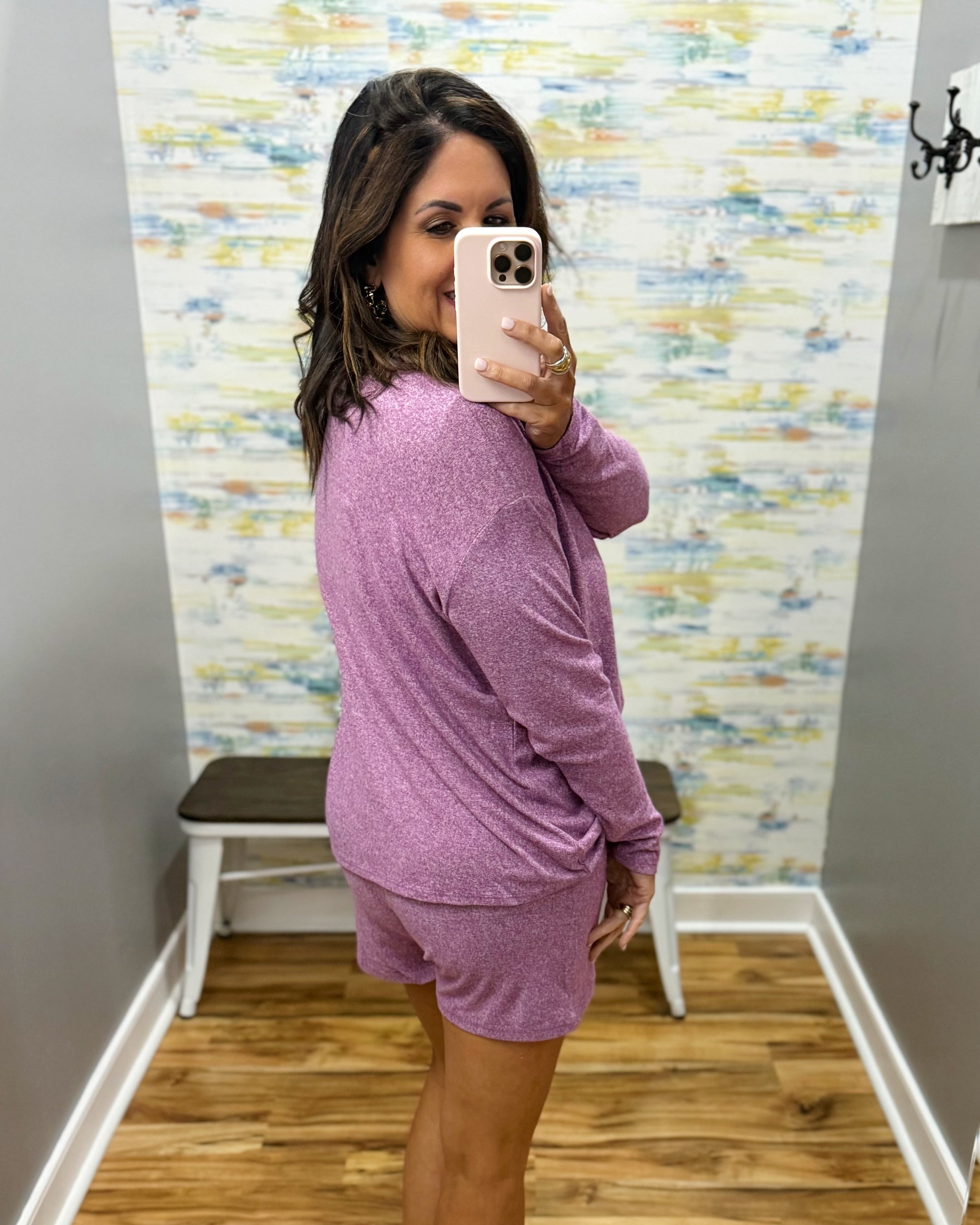 woman wearing light plum lounge top and shorts set.