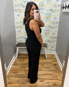 woman wearing a black jumpsuit