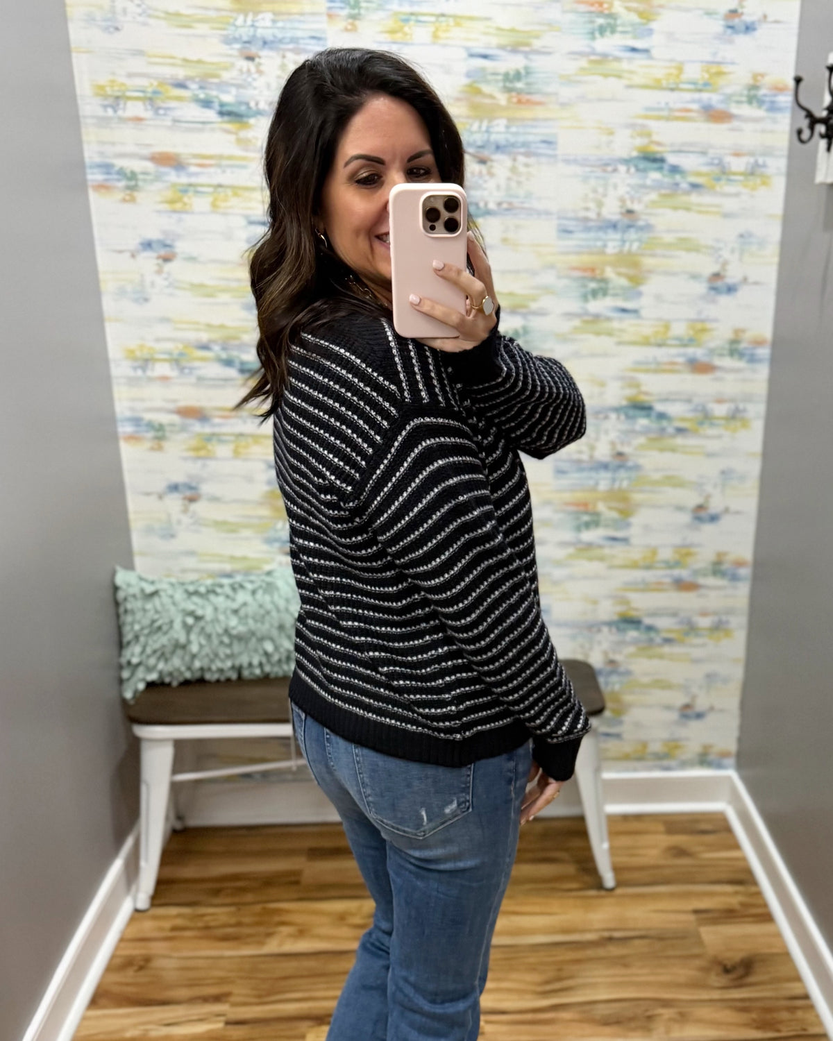 woman taking a selfie wearing a navy and white stripe sweater.
