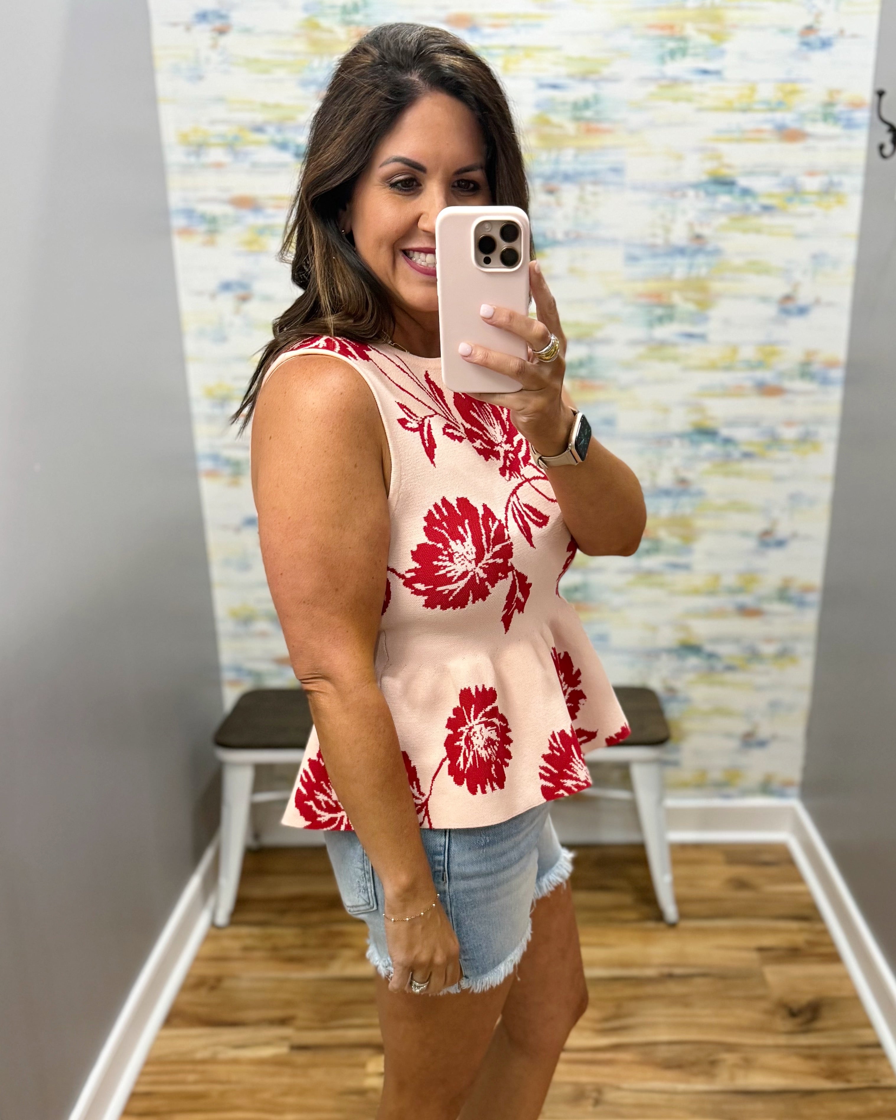 woman wearing a floral sweater tank. 