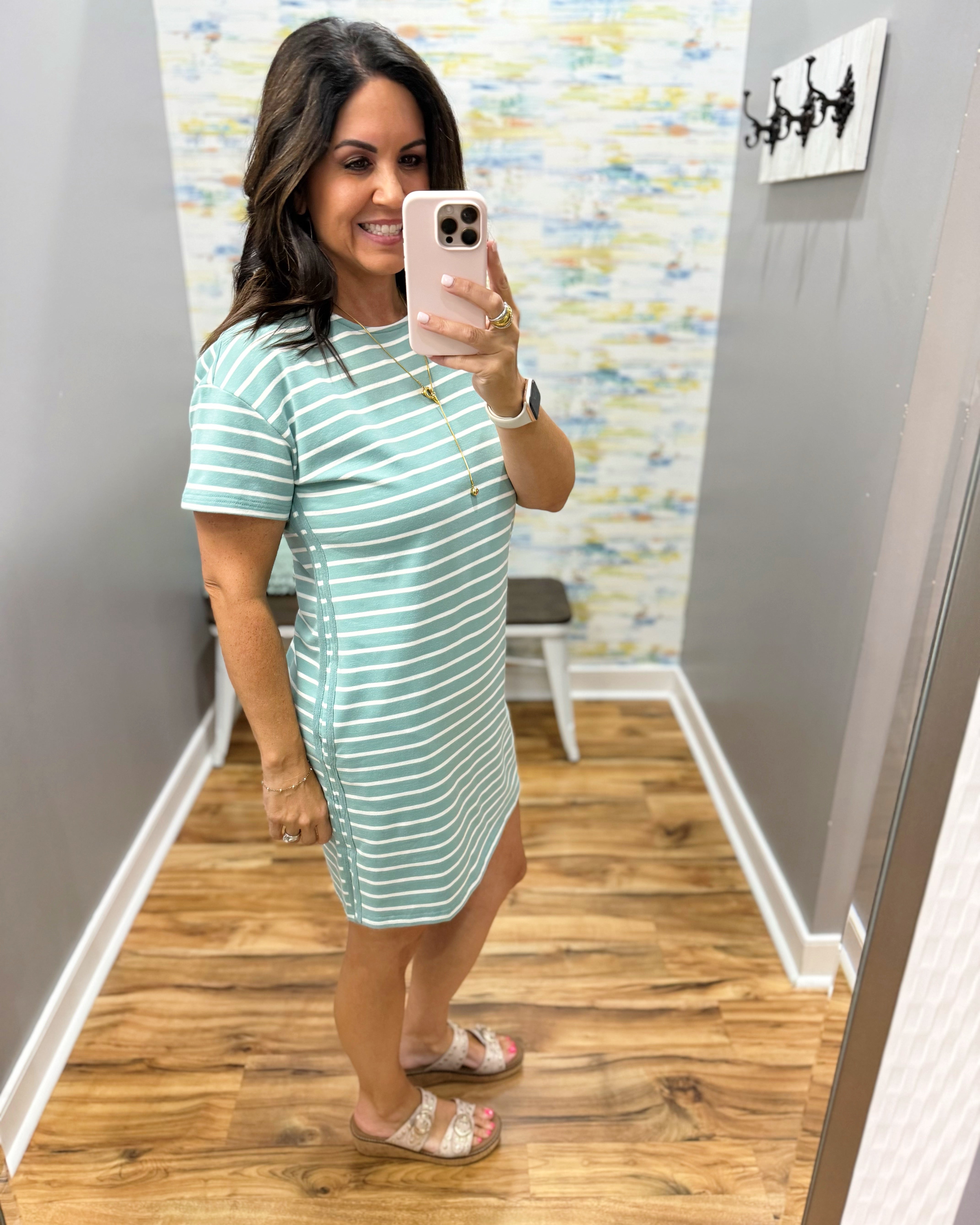 woman wearing a dark sage and white stripe dress.