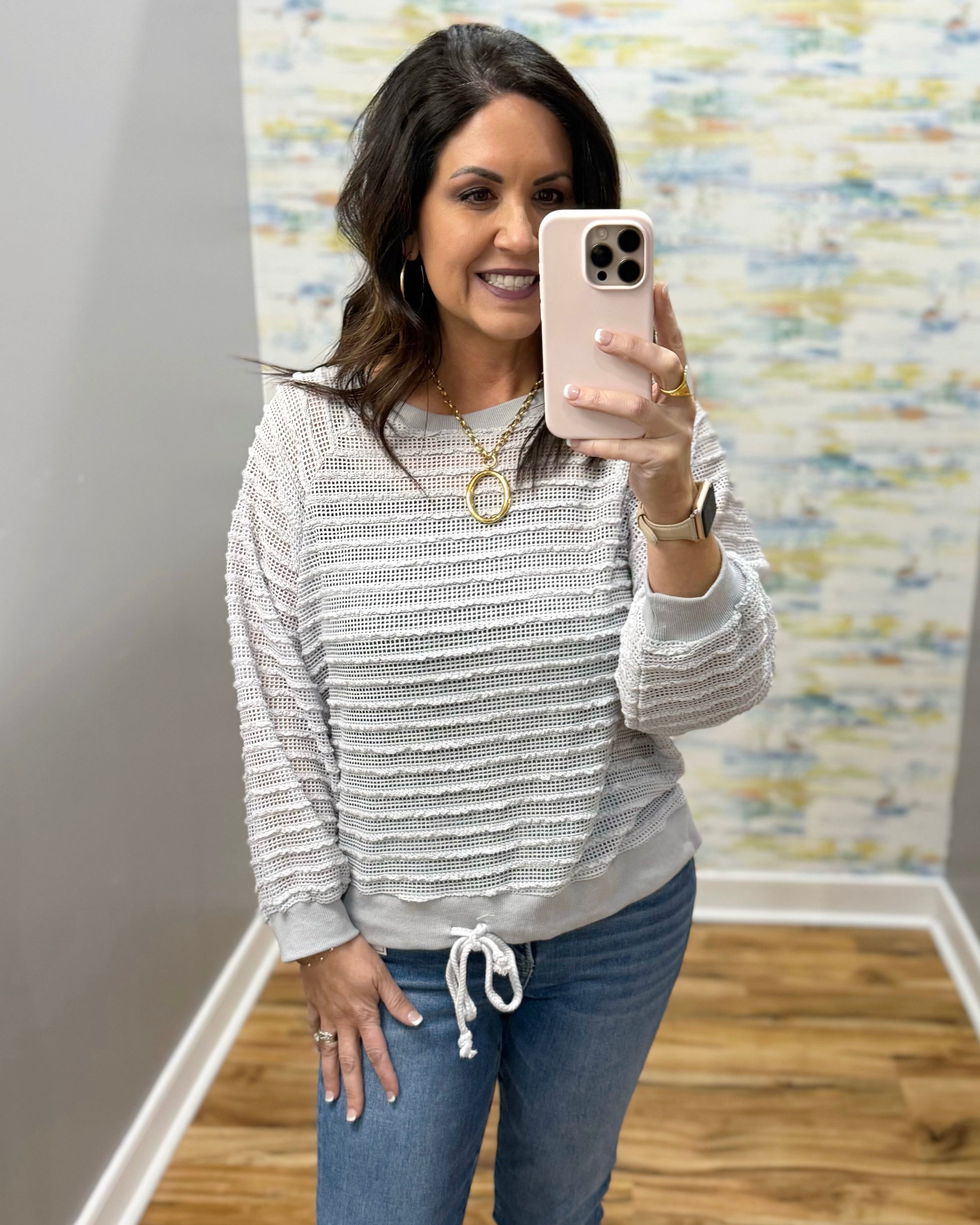 woman wearing a lightweight sweater top in stone color