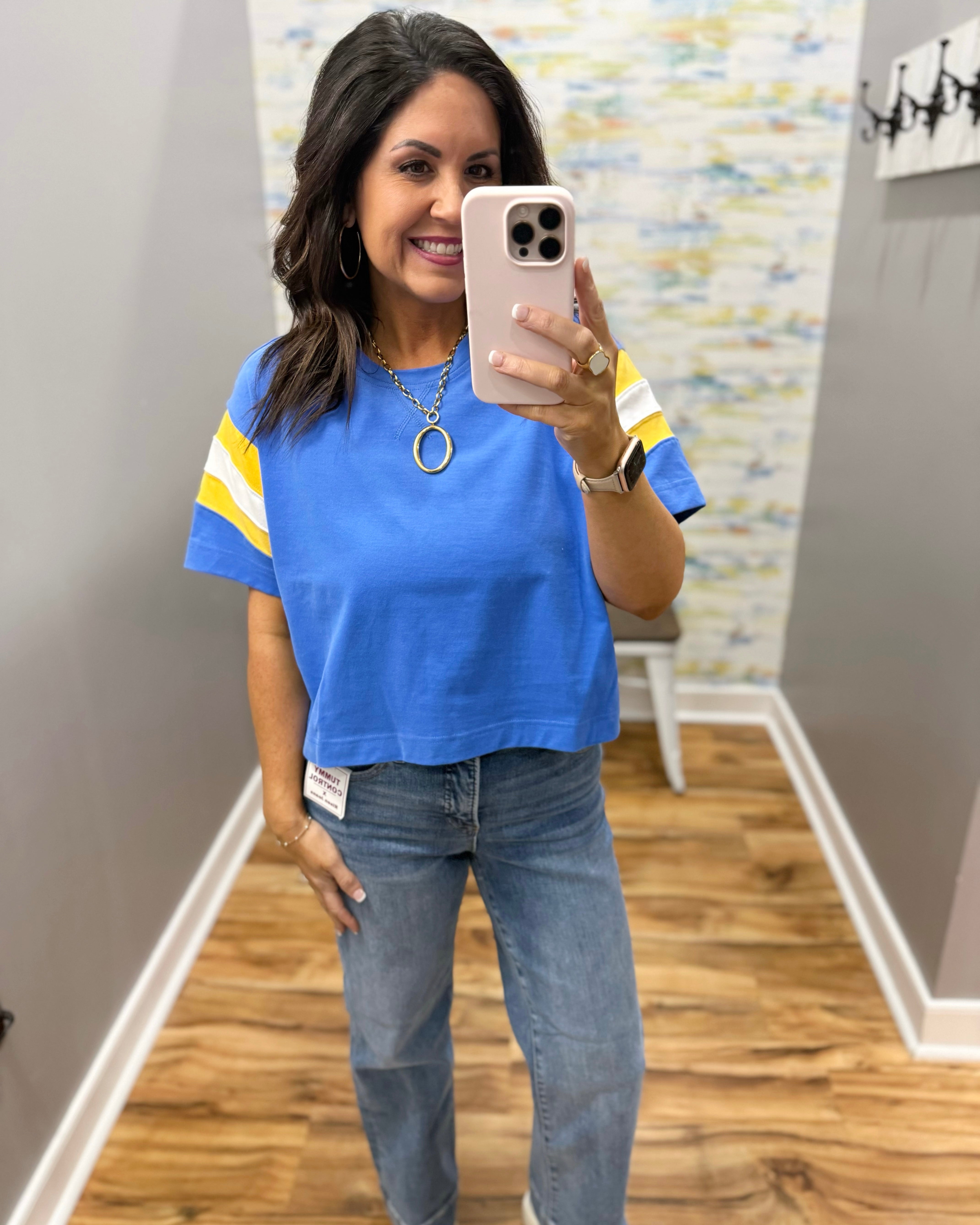 woman wearing blue tee with chunky gold necklace