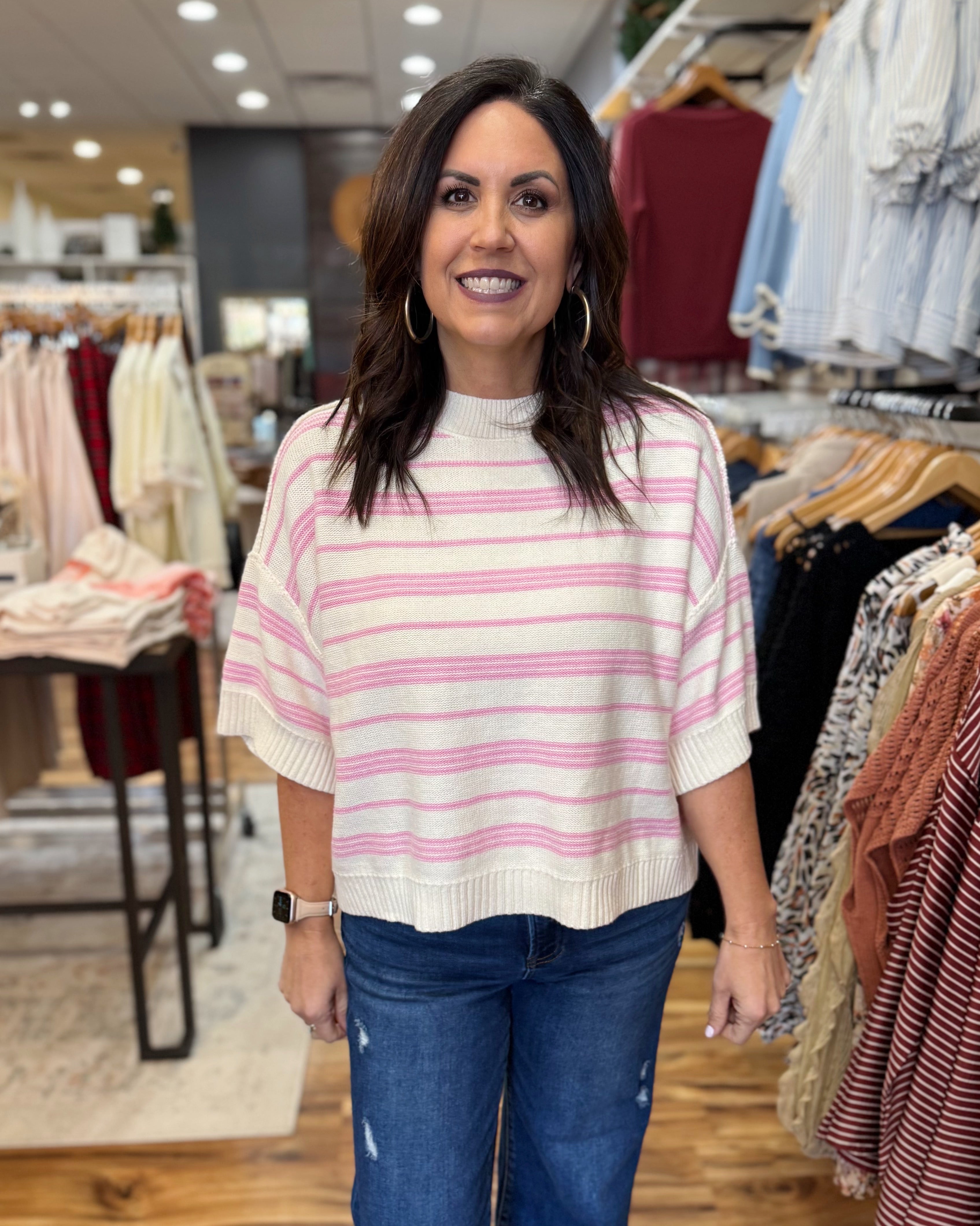 Woman wearing a striped sweater in a clothing store