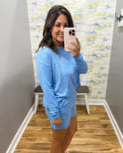 woman wearing blue lounge top and shorts set.