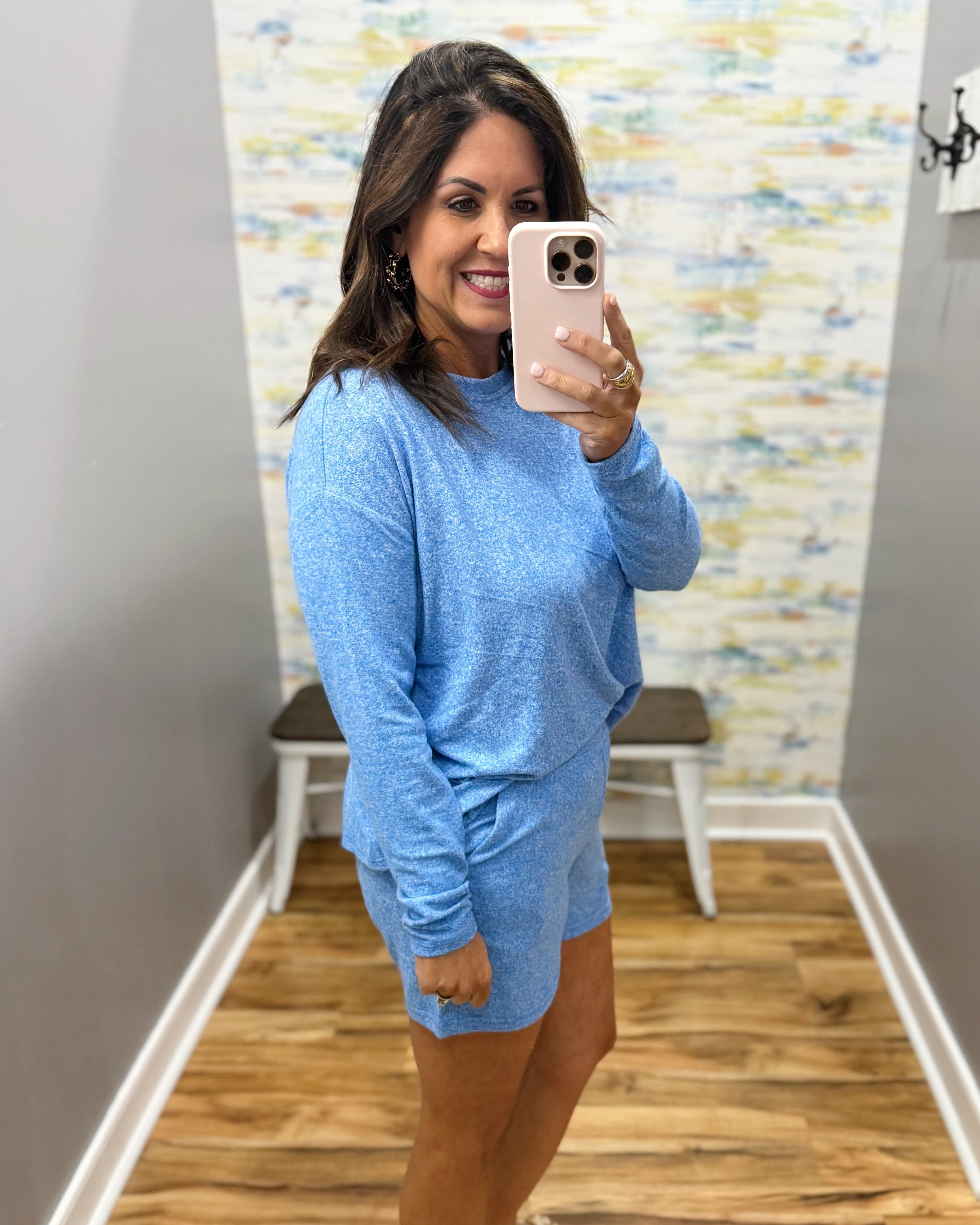 woman wearing blue lounge top and shorts set.